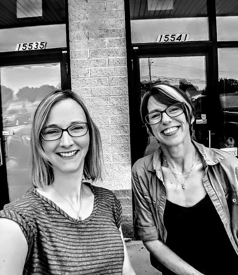 Proud Nicki and Megan pose outside clinic